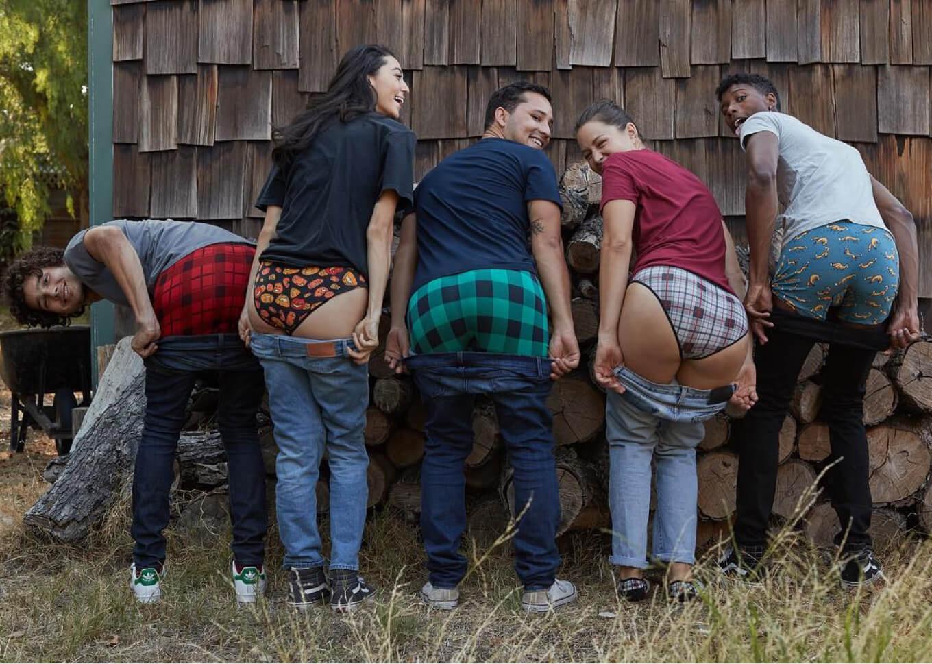 Group of five pulling their pants down to reveal their MeUndies underwear in plaid, gingham and animal patterns